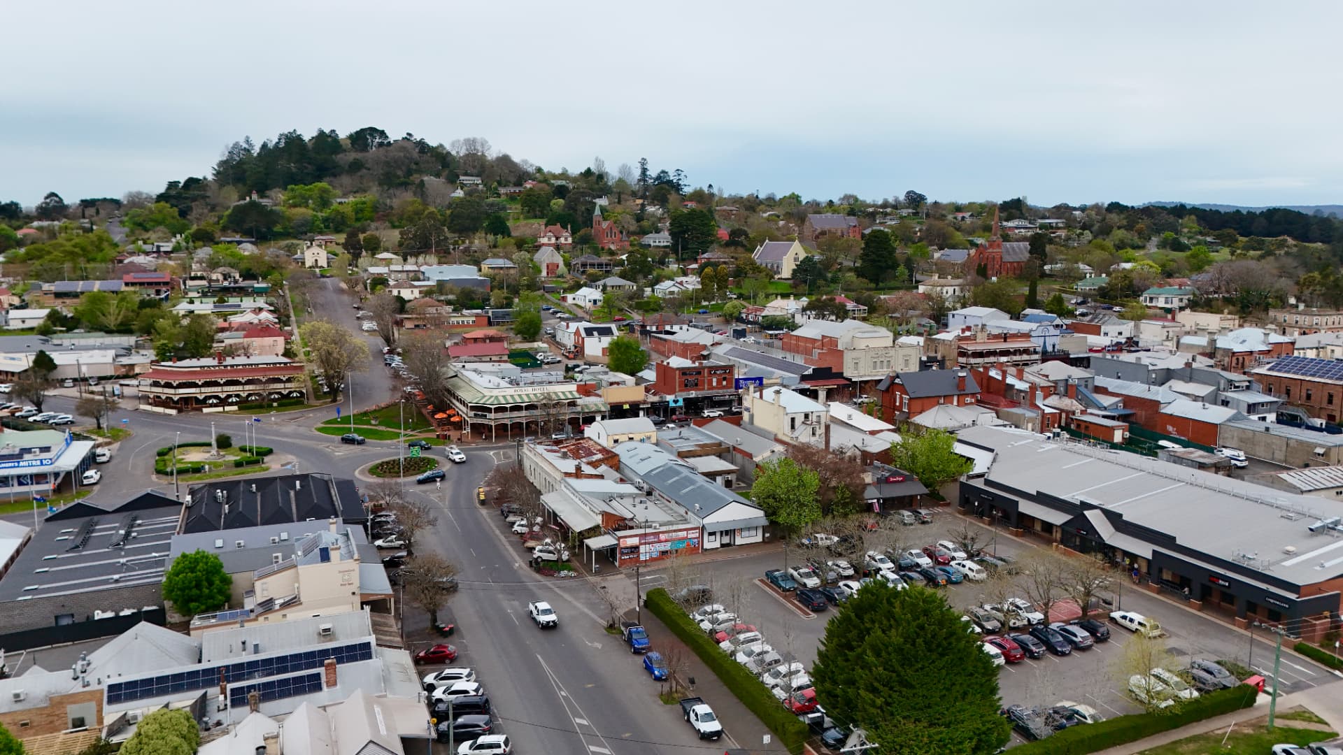 Aerial view across Daylesford town centre, surrounding hills and church spires