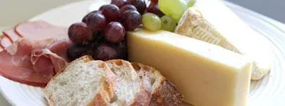 Cheese platter with crackers and fruit served in the villa