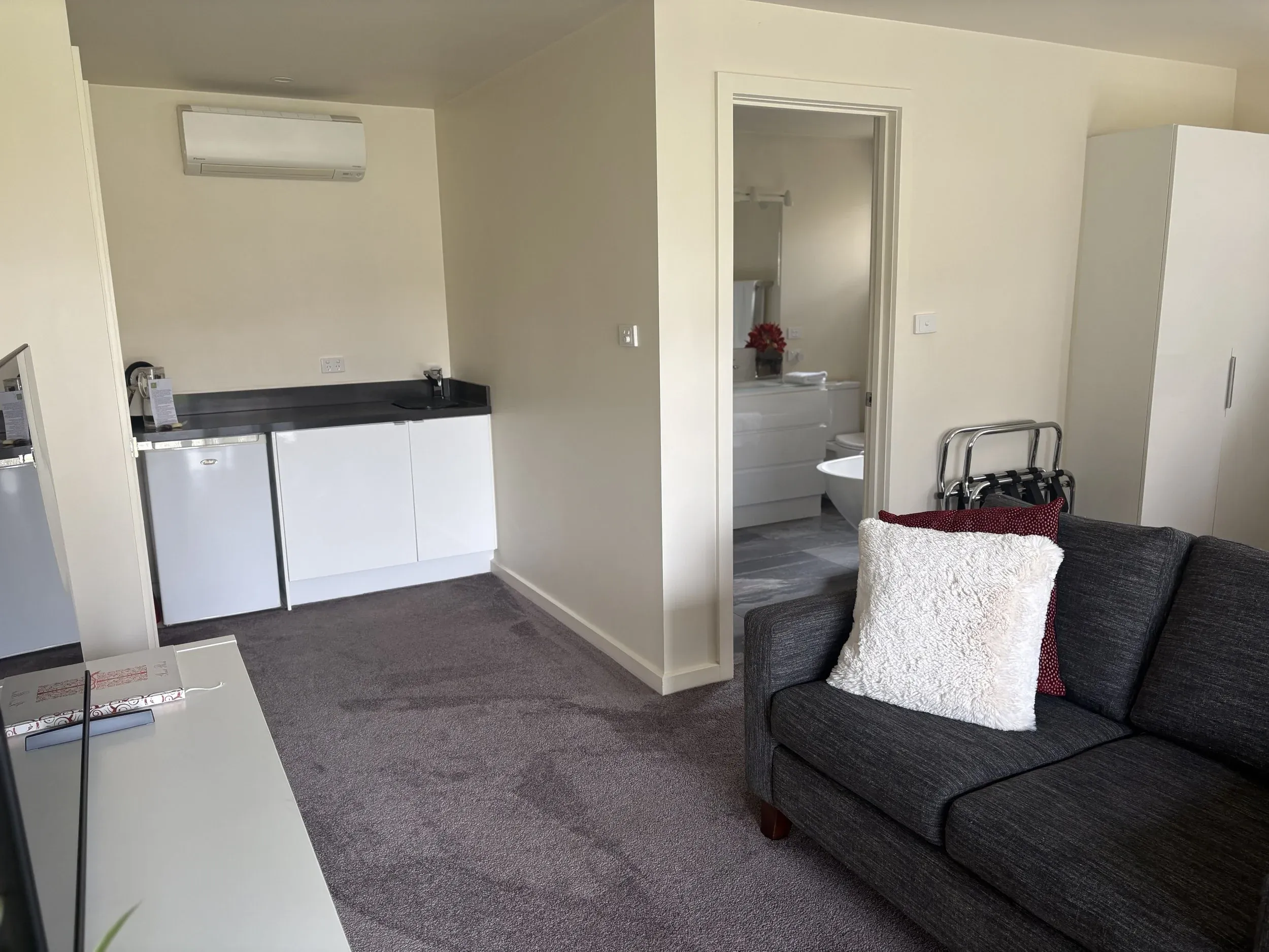 Villa kitchenette with bar sink, kettle and adjacent living space