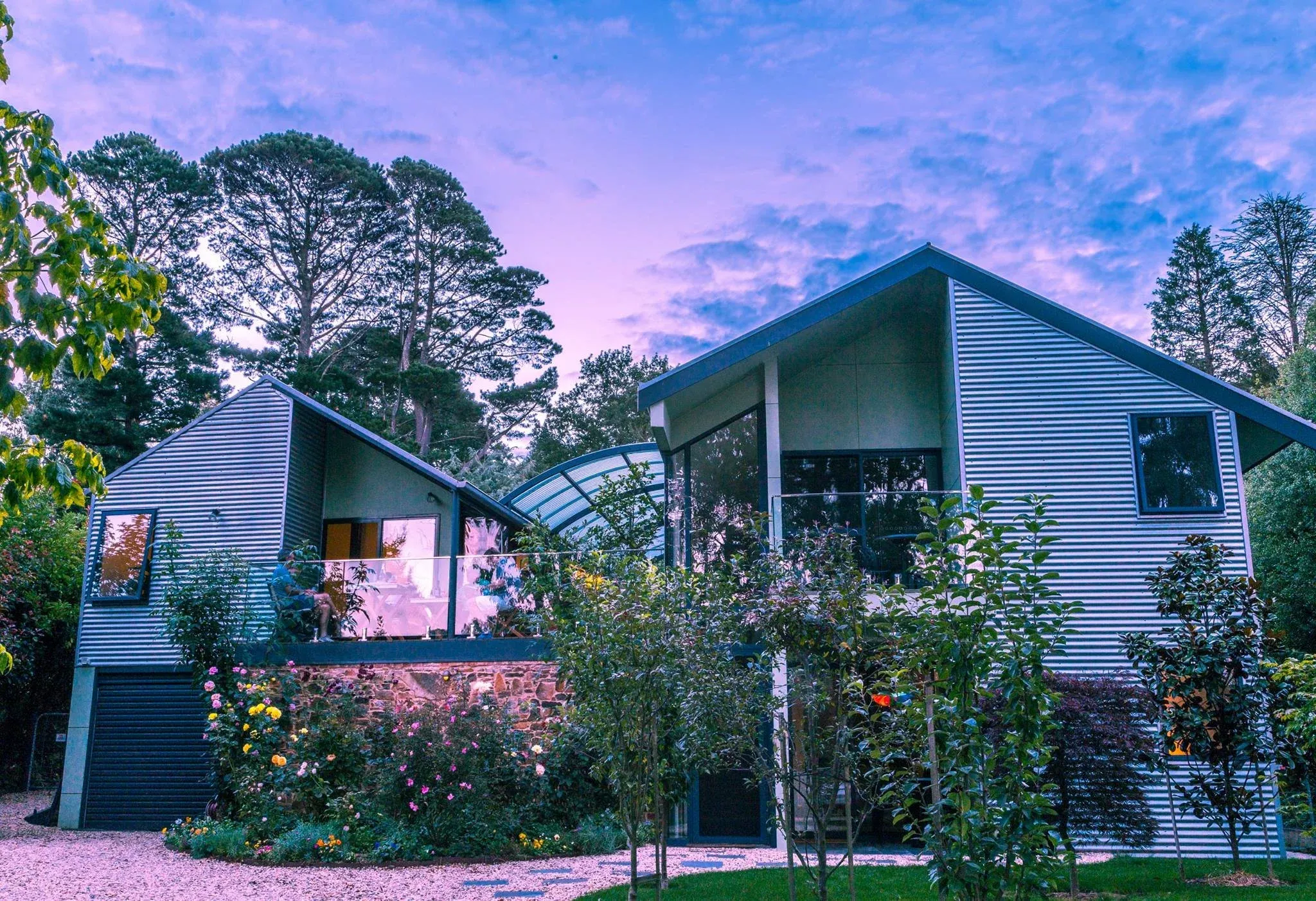 Trentham Lake Villas lit at twilight beside the lake